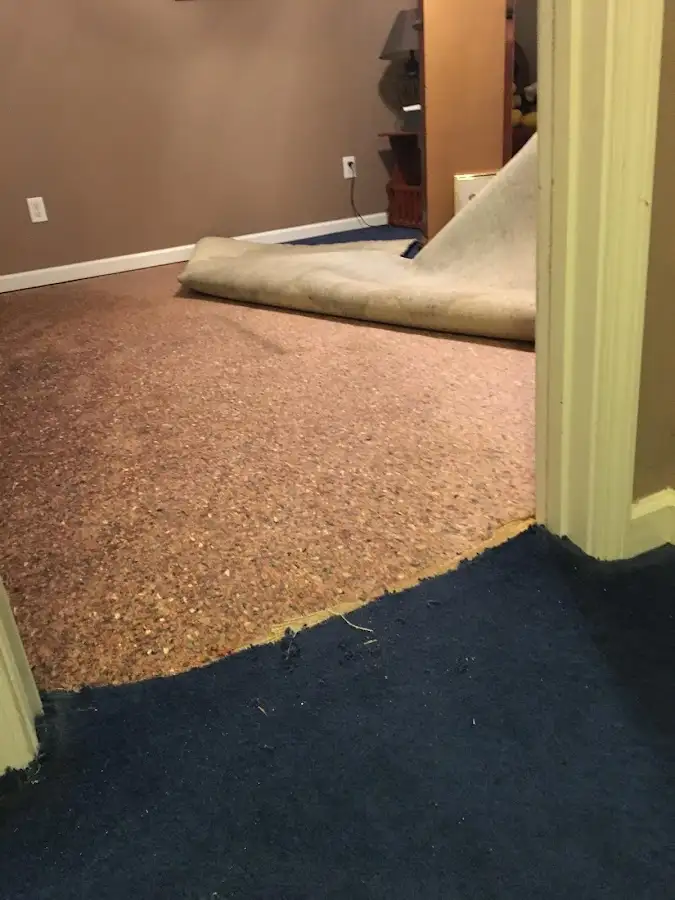 Carpet pad removal revealing water damage during Drying & Dehumidification in Grantsville